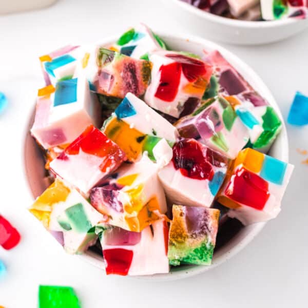 Square image of Broken Glass Jello dessert cubes with colorful gelatin pieces in creamy white gelatin