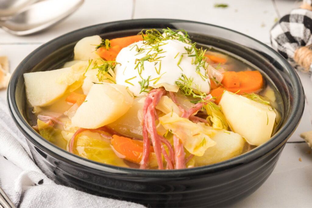 black bowl with corned beef and cabbage soup