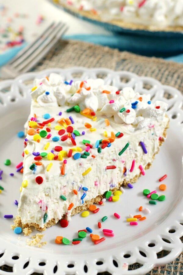 No-Bake Funfetti Cheesecake close up on a plate with rainbow sprinkles.