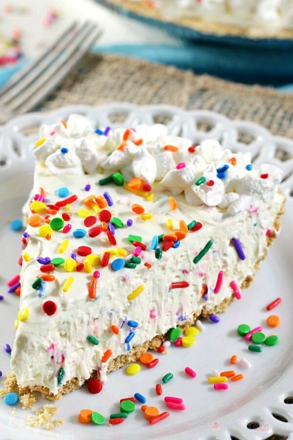 No-Bake Funfetti Cheesecake on a plate with rainbow sprinkles.
