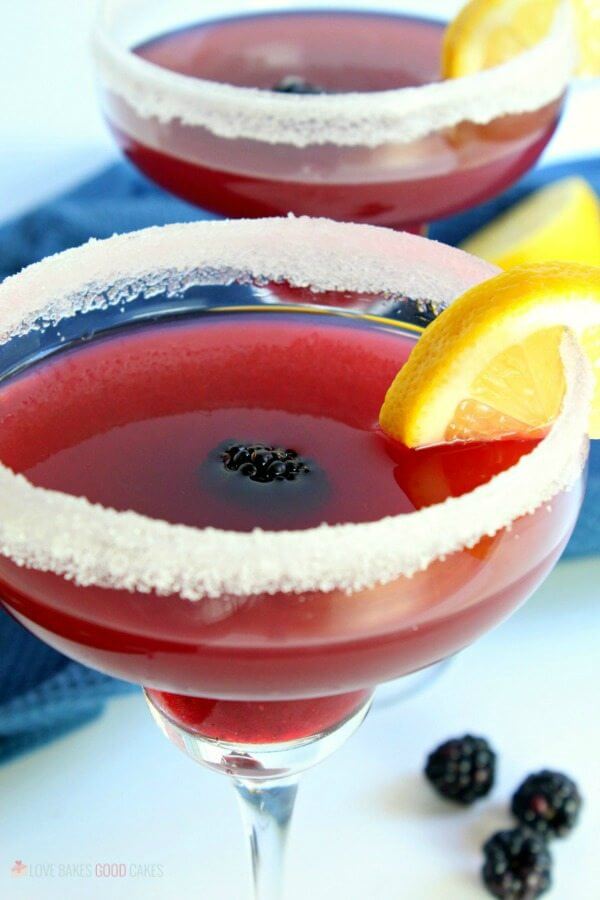 Blackberry Lemonade Margarita in two glasses with fresh fruit.