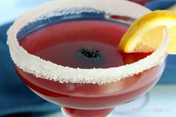 Blackberry Lemonade Margarita in a glass with fresh fruit.