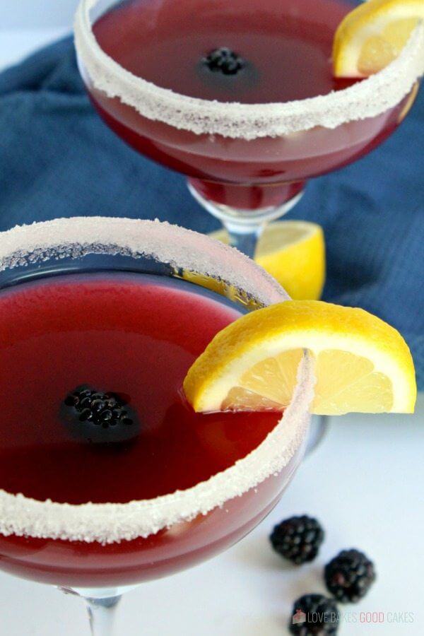 Blackberry Lemonade Margarita in two glasses with fresh fruit close up.