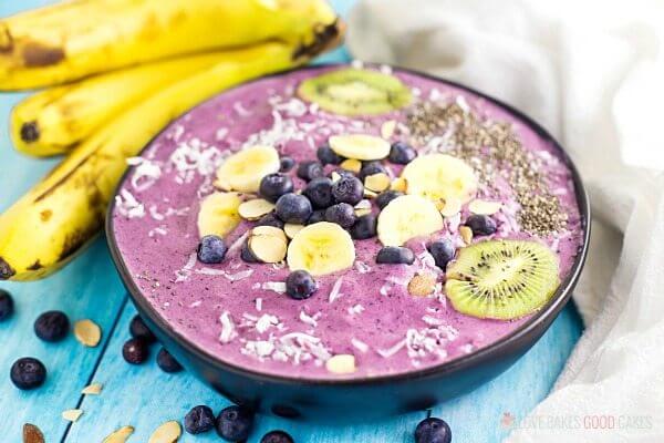 Blueberry Banana Smoothie in a Bowl with fresh bananas and kiwis.
