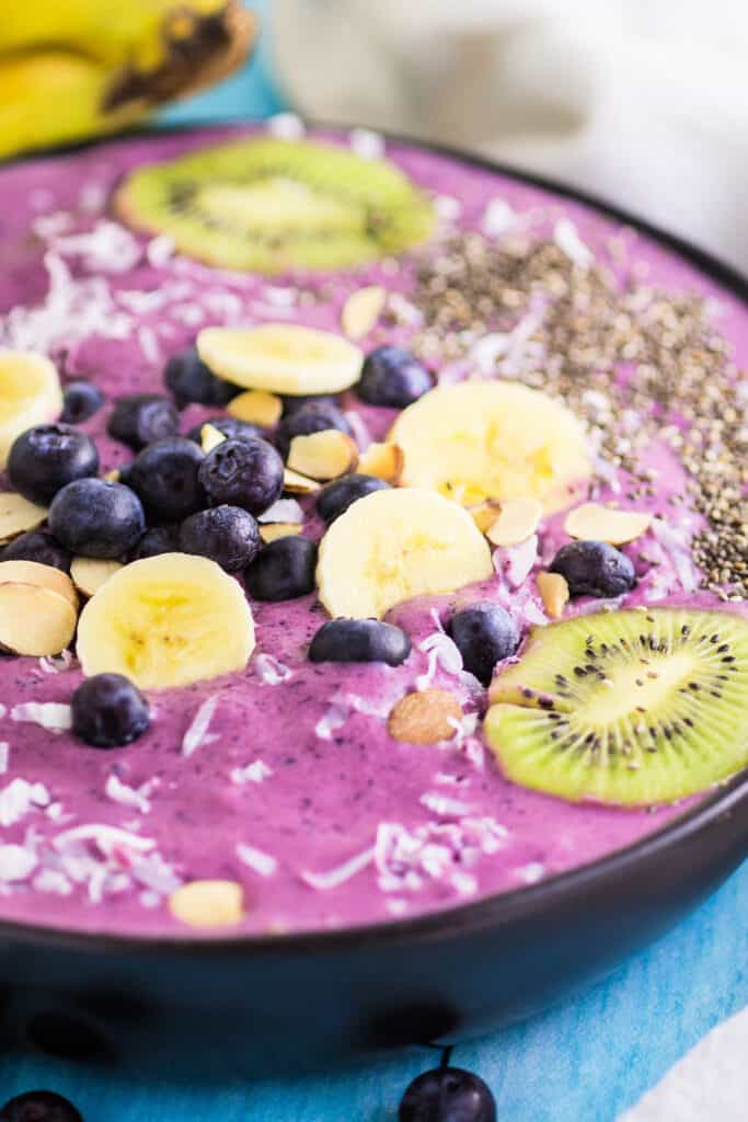 closeup of fruit and chia seeds on top of smoothie bowl
