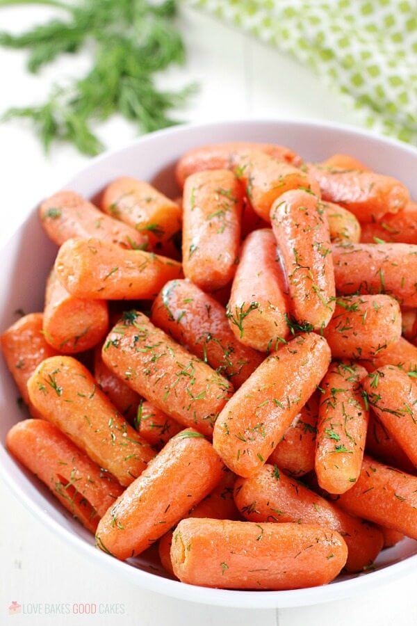 Dill Butter Carrots in a white bowl close up.