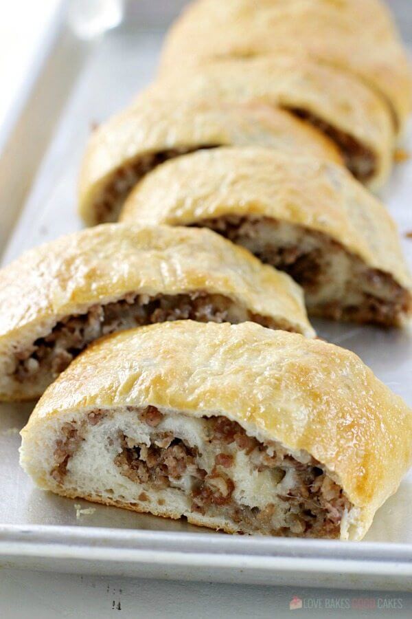 Sausage Bread sliced on a baking sheet.