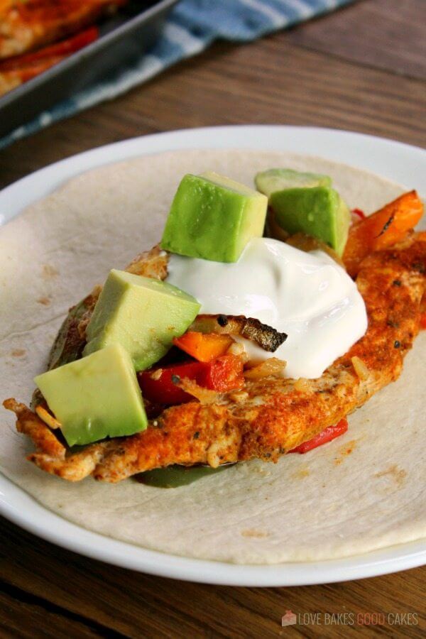 Sheet Pan Chicken Fajitas on a flour tortilla.