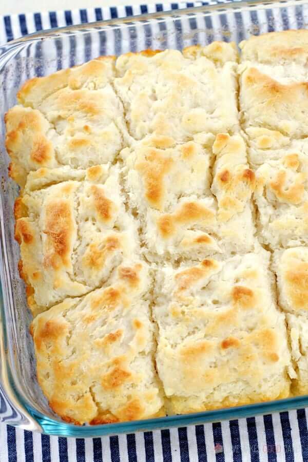 Butter Dip Biscuits sliced in a baking dish.