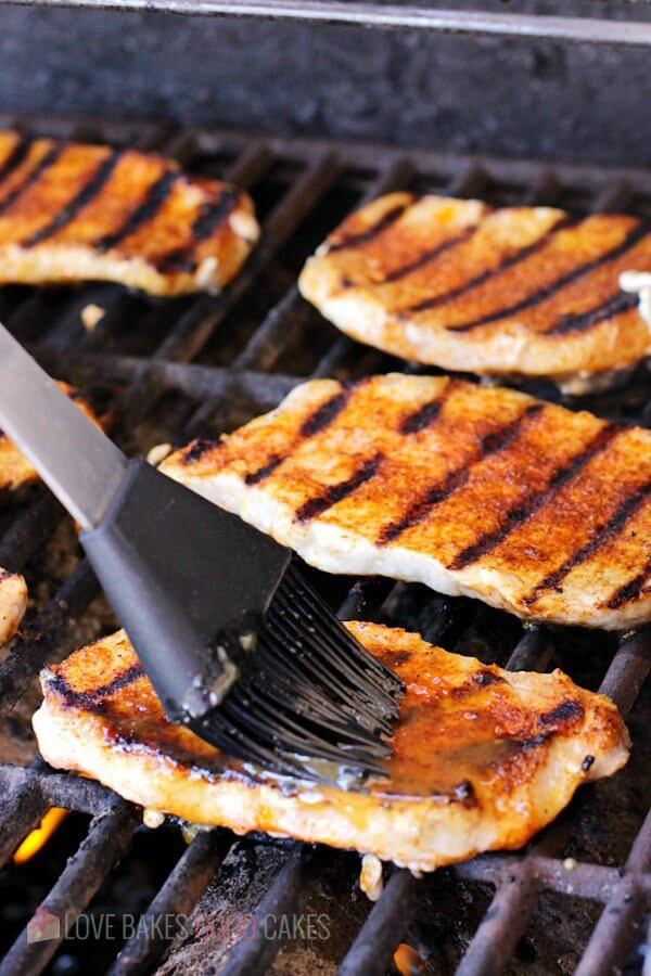 Dijon-Peach Pork Chops cooking on the grill.