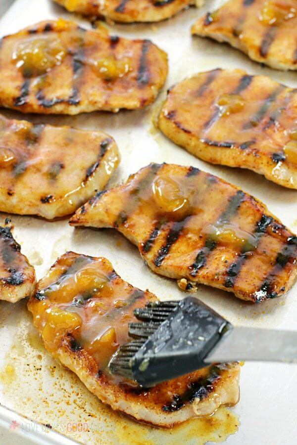 basting pork chops with dijon-peach glaze
