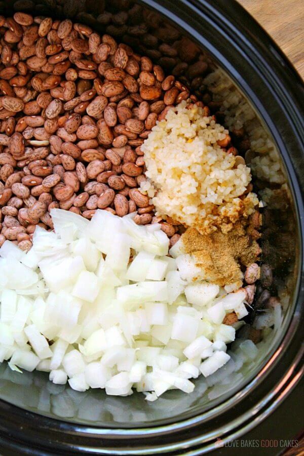 Slow Cooker Refried Bean ingredients in a slow cooker.