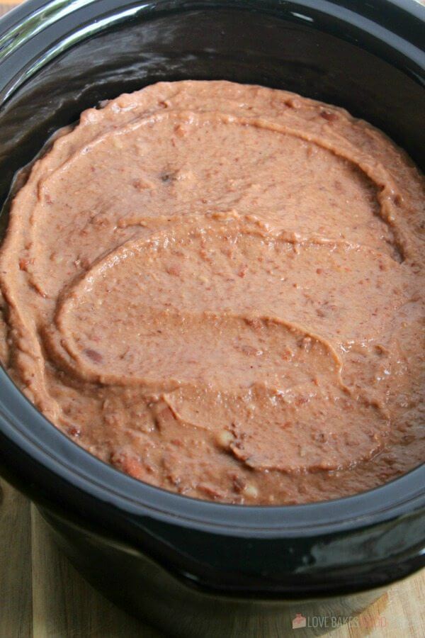 Slow Cooker Refried Beans in a slow cooker close up.