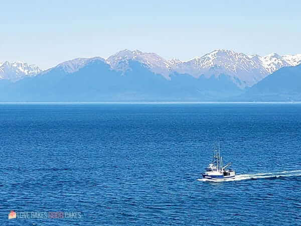 A pilot boat making its way to a cruise ship.