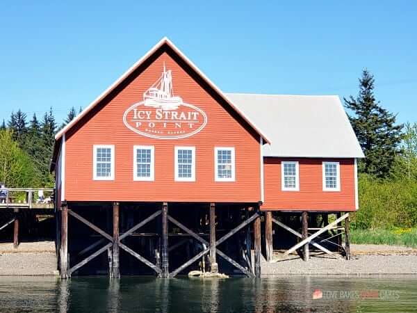 Icy Strait Point building on the shore of a body of water.