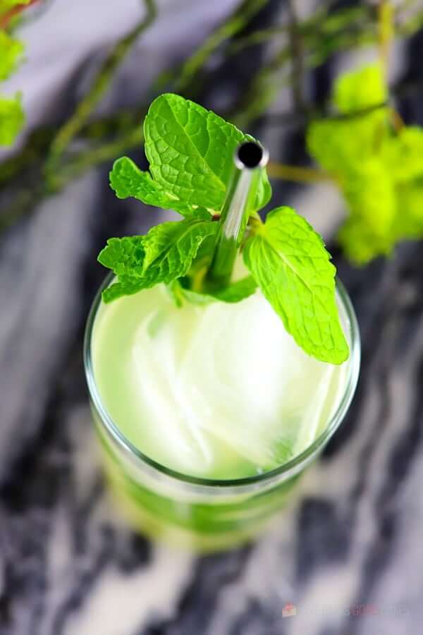 Pineapple Mojito (with Virgin "Nojito" Option) in a glass with a straw close up.