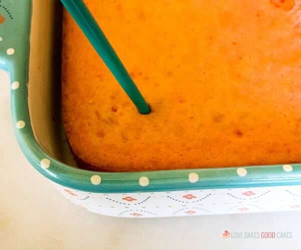 Boozy Strawberry Margarita Poke Cake right after coming out of the oven.