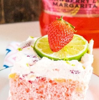 Get the party started with this Boozy Strawberry Margarita Poke Cake! Margarita mix and instant pudding amp up a boxed cake mix to become your new favorite summer dessert!