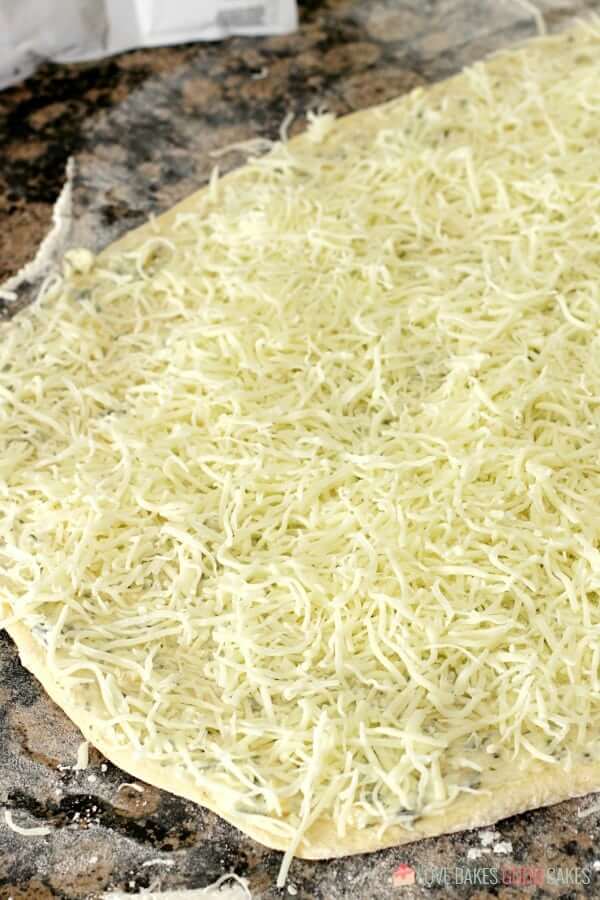 Cheesy Garlic Bread "Cinnamon" Roll dough with shredded cheese.
