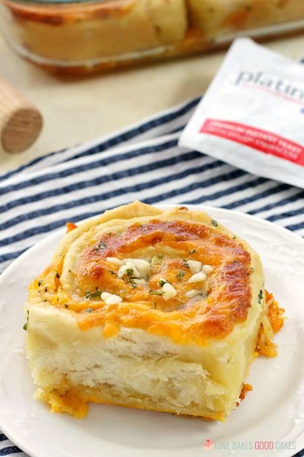 Tired of the same old garlic bread?! These Cheesy Garlic Bread "Cinnamon" Rolls are crusty, cheesy, and easier than you might think! Cheesy Garlic Bread "Cinnamon" Roll on a plate.