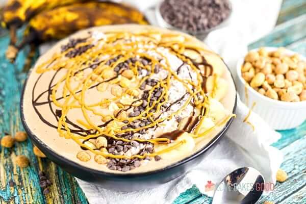 Chocolate Peanut Butter Smoothie in a bowl with fresh bananas and toppings.