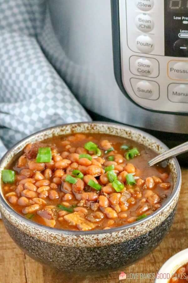 Instant Pot Baked Beans in a bowl with a spoon.