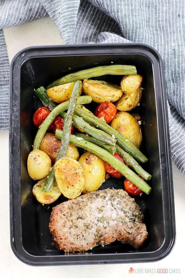 Italian Pork Chop Sheet Pan Dinner in a storage container.