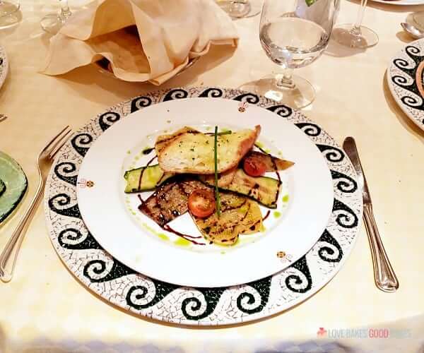 Food on a plate inside a restaurant on a cruise ship.