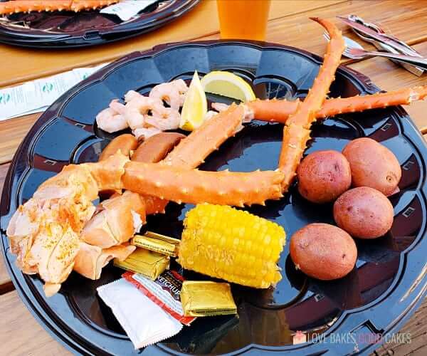 Seafood Feast on a plate with crab legs, corn on the cob, russet potatoes and shrimp.