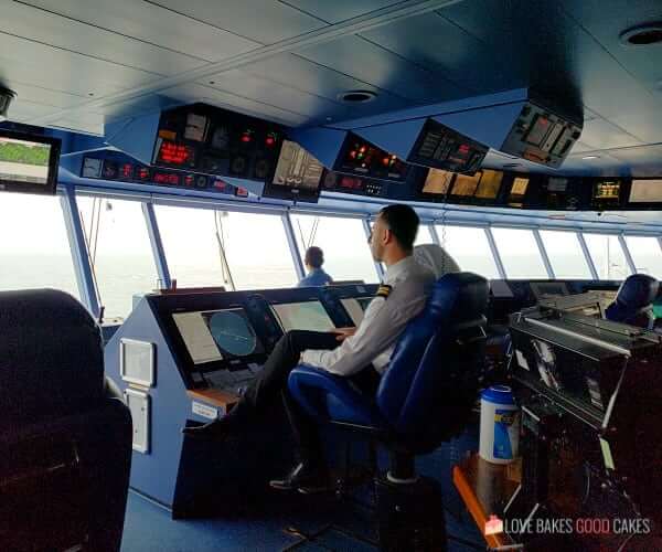 The bridge of the Island Princess cruise ship with the captain sitting at the helm.