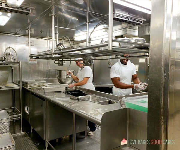 Dishwashers on a cruise ship inside the kitchen area.