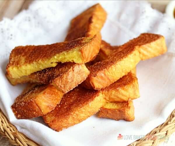 Air Fryer French Toast Sticks piled up in a basket.