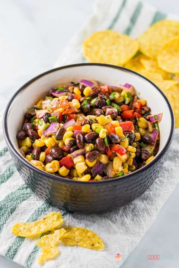 Black Bean and Corn Salsa in a bowl with tortilla chips.