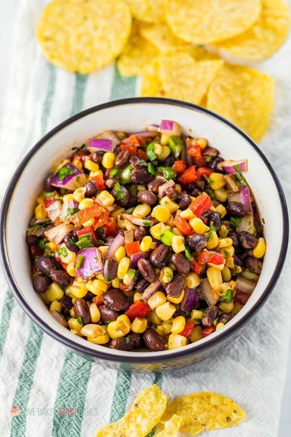 Black Bean and Corn Salsa in a bowl with tortilla chips.