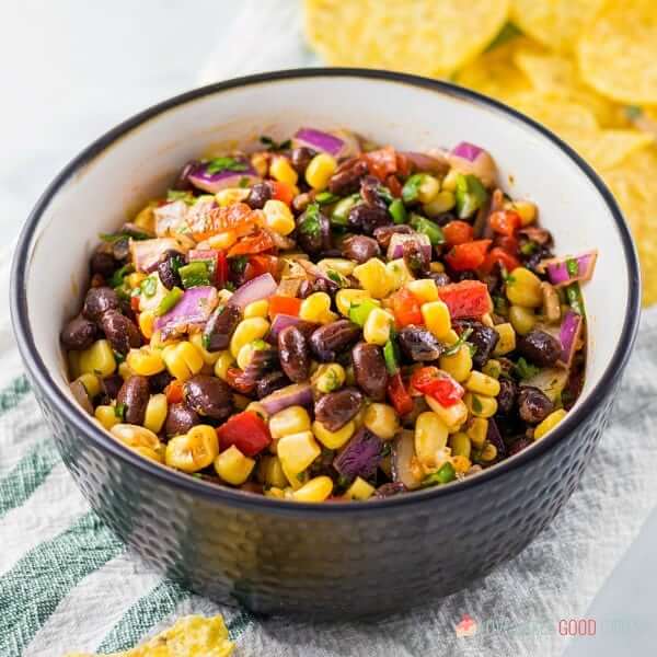 Black Bean and Corn Salsa in a black bowl close up.