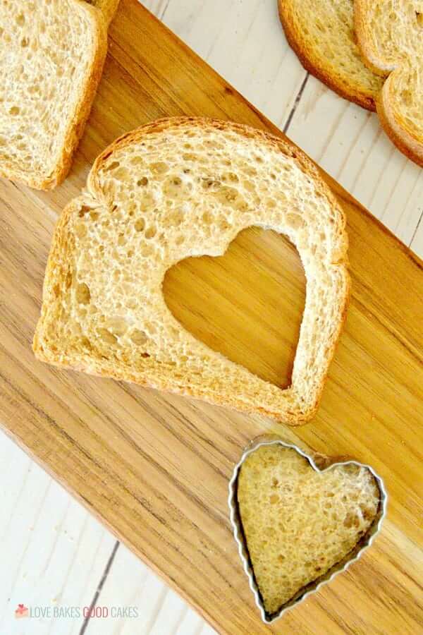 Fairy Sandwich bread slices on a cutting board with a heart-shaped hole cut out of one slice.