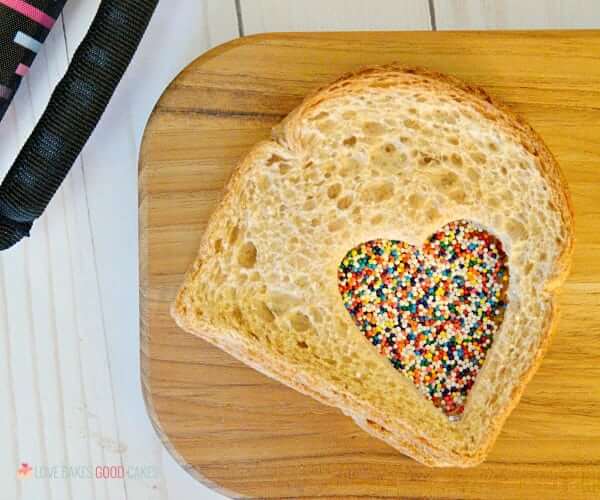 Fairy Sandwich on a cutting board with rainbow sprinkles.