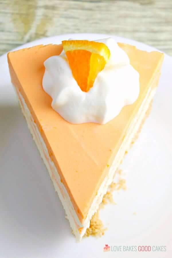 No-Bake Orange Creamsicle Cheesecake slice on a plate.