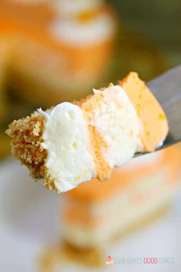 No-Bake Orange Creamsicle Cheesecake piece on a spoon.