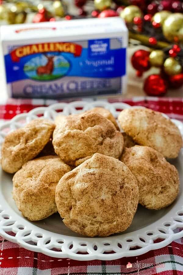 Snickerdoodle Cream Cheese Cookies piled up on a white plate.