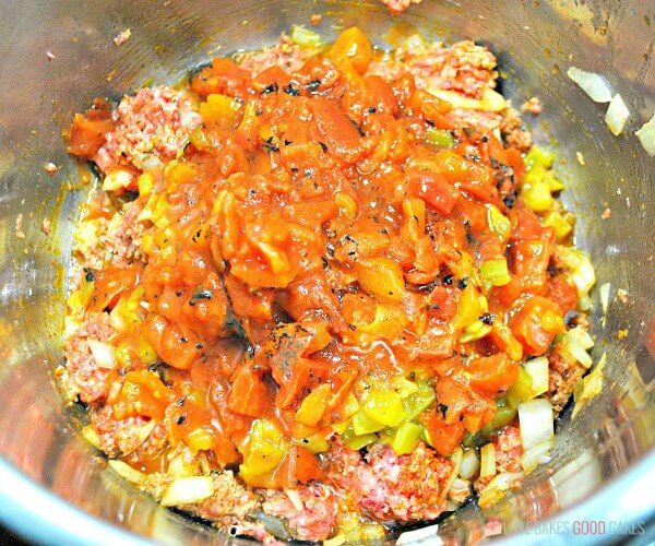 Instant Pot Mexican Queso being mixed up in a metal bowl.