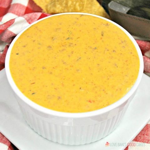 Instant Pot Mexican Queso is perfect for game day or your next fiesta! Everyone will love this cheesy dip filled with seasoned beef, chilies, and tomatoes!