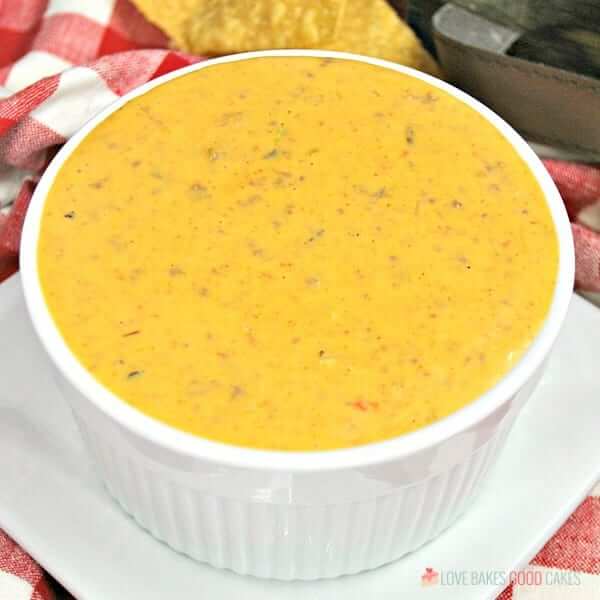 Instant Pot Mexican Queso is perfect for game day or your next fiesta! Everyone will love this cheesy dip filled with seasoned beef, chilies, and tomatoes!