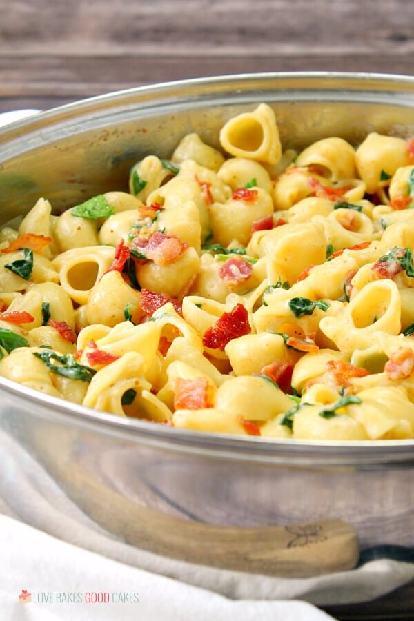 One Pot Creamy Bacon Spinach Pasta close up in a skillet.