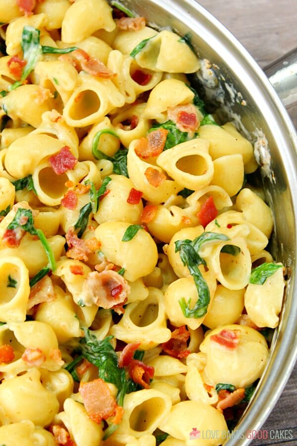 One Pot Creamy Bacon Spinach Pasta close up in a skillet.