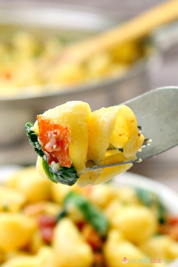 One Pot Creamy Bacon Spinach Pasta up close on a fork.