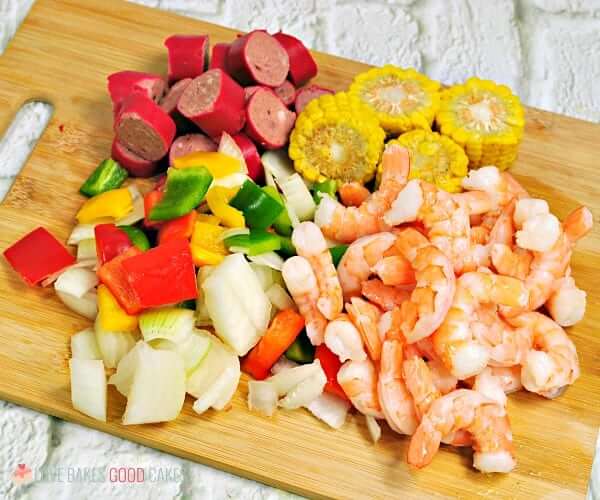 Shrimp Boil Foil Packet ingredients on a cutting board.