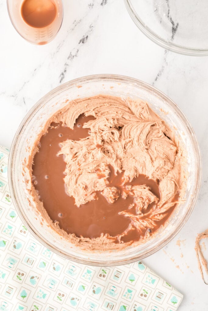 Final addition of chocolate milk to complete the Chocolate Milk Cake batter