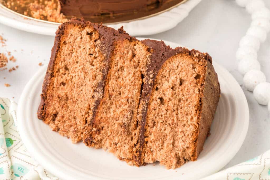 Close-up of three slices of soft, moist Chocolate Milk Cake Recipe with chocolate frosting