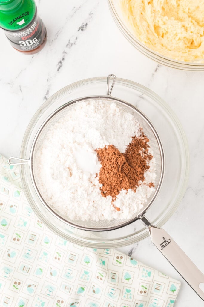 Powdered sugar and cocoa powder sifted together for chocolate milk cake